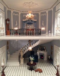 the inside of a doll house with stairs and furniture in it's center area