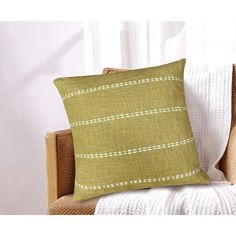 a green pillow sitting on top of a chair