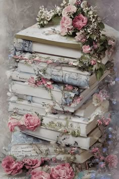 a stack of books with pink flowers on top