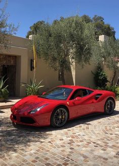 a red sports car parked in front of a house