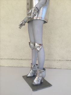 there is a silver statue that looks like a woman's legs are wrapped around