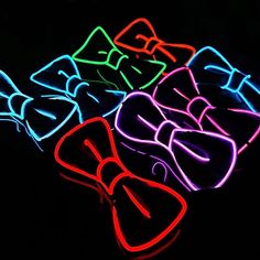 neon bow ties and glasses in the dark