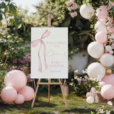 a welcome sign with pink and white balloons