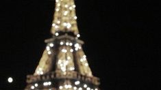 the eiffel tower is lit up at night