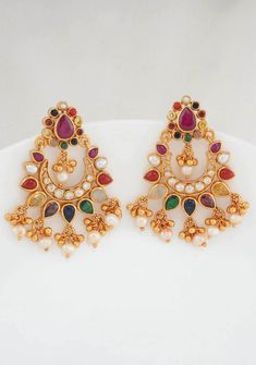 This 92.5 Silver, 24 kt gold-plated stylish Chandbali Earring oair  is studded with semi-precious stones inspired by navratna patterns.  Height-55 mm width-40 mm Note Product Care: To maintain the elegance of your silver jewelry, proper care is essential. Keep it away from sweat, water, and sleep to avoid tarnishing. Also, avoid any contact with perfumes, lotions, sunscreen, or chemicals, and store it in a box. For cleaning, use a soft cloth and avoid friction.. Note: Each piece is meticulously Navaratna Earrings Gold, Festive Multicolor 22k Gold Earrings, Multicolor Temple Jewelry Earrings For Navratri, Temple Jewelry Style Multicolor Earrings For Navratri, Multicolor Gold-plated Earrings For Diwali, Multicolor 22k Gold Temple Jewelry Earrings, Multicolor Gold Plated Earrings For Diwali, Traditional Gold Multi-stone Earrings, Multicolor Temple Jewelry Bridal Earrings For Diwali