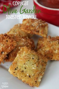 four pieces of fried ravioli on a white plate