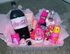 a basket filled with lots of different types of cosmetics and personal care products on the floor