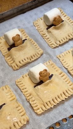 four homemade pastries with marshmallows on them in the shape of teddy bears