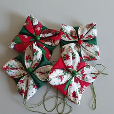 four christmas bows tied together on a table