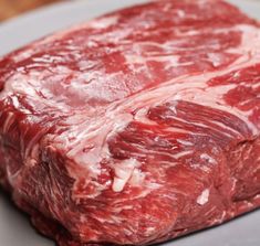 raw meat sitting on top of a cutting board