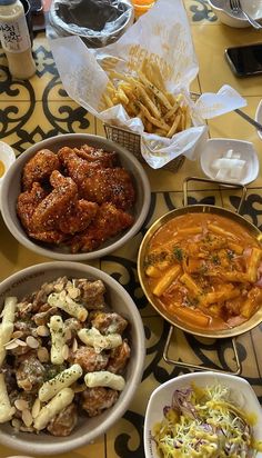 several different bowls of food on a table