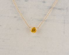 This beautiful and simple necklace is part of our Floating Gem Collection. The rich yellow sapphire is set in a simple three prong setting and is stationary on the cable chain. This necklace can easily be worn everyday or for a night out. Check out our shop for more of this Collection! Metal: 14k Yellow Gold Gemstone Type: Yellow Sapphire Gemstone Shape: Round Gemstone Size: 5.25mm Gemstone Weight: 0.88cts Design Elements: minimalist, solitaire Condition: New Item Weight: 2.5g Item Number: 43846 Fine Jewelry Yellow Birthstone Necklaces, Yellow Birthstone Necklaces In Fine Jewelry Style, Yellow Birthstone Fine Jewelry Necklaces, Yellow Birthstone Fine Jewelry Necklace, Yellow Birthstone Round Pendant Necklace, 14k Gold Yellow Birthstone Jewelry, Yellow 14k Gold Jewelry With Birthstone, Minimalist Yellow Jewelry With Birthstone, Minimalist Yellow Birthstone Jewelry