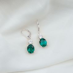 Product Details Flaunt these effortless Emerald Drop Earrings and make a sophisticated statement every time you go out. The 8X10 MM Lab Grown Emerald elegantly set in prong setting accompanied by Round Moissanite sparkling from the top of it. Feel free all the time when you wear these emerald earrings as they are crafted with lever back closures which keep them safe in the earlobe and provide you with all-day comfort. Get this gorgeous pair for yourself or surprise your beloved by presenting the Formal Oval Emerald Jewelry, Formal Drop Emerald Earrings, Elegant Green Emerald Earrings, Elegant Emerald Drop Crystal Earrings, Emerald Drop Earrings, Pierced, Emerald Earrings Drop, Lab Created Emerald, Prom Jewelry, Special Occasion Outfits