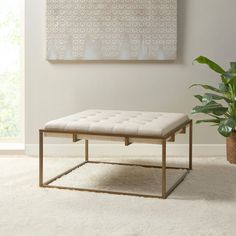 a living room with a white rug and a large painting on the wall above it