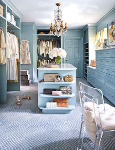 a closet with blue walls and shelves filled with clothes