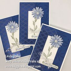 three cards with blue and white designs on them, one has a flower in the middle