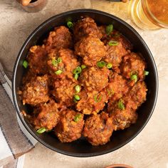 a bowl filled with meatballs on top of a table