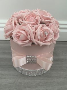 a pink hat box with roses in it