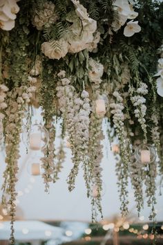 flowers hanging from the ceiling at a wedding reception