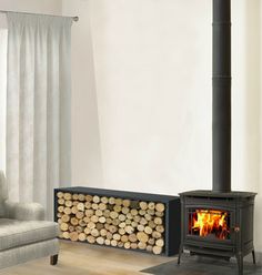 a living room filled with furniture and a fire place next to a chair on top of a hard wood floor