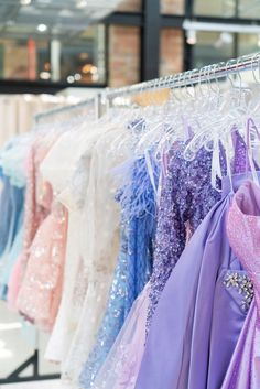 Homecoming dresses showcased on a clothing rack.