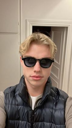 a man with sunglasses on taking a selfie