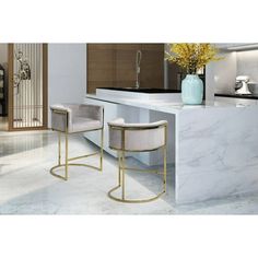 two white stools sitting in front of a counter with yellow flowers on the table