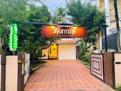 the entrance to a hotel with an orange sign above it that says ayromy