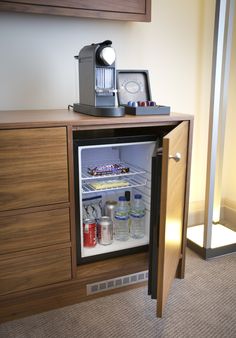 an open refrigerator door in a small room