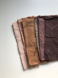 four different colors of fabric on a white surface