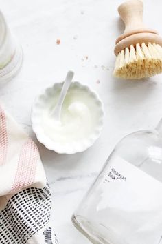 a white table topped with dishes and a brush