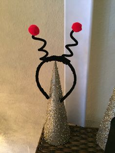 an image of a party hat made out of yarn and paper mache with red pom poms