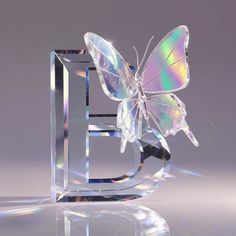 a glass sculpture with a butterfly on it's back and the letter e in the middle