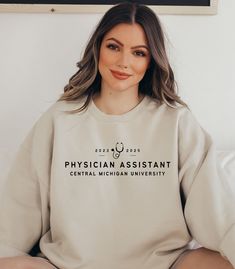 "PLEASE PUT WHAT YEARS AND WHAT COLLEGE IN THE COMMENT BOX WHEN PURCHASING Graduating this year from your Physician Assistant, Nurse, Medical, or nurse practitioner school program or know someone who is? This is a great gift! If you would like a different year on your sweatshirt please put that in the comment box as well for personalization.   This unisex heavy blend crewneck is made of polyester and cotton to provide a comfortable and cozy feel. The collar is ribbed knit and retains its shape after every wash. ITEM DETAILS:  -50% cotton, 50% polyester -Medium-heavy fabric  -Loose fit -Sewn-in label -Runs true to size, BUT if you're looking for a more \"baggy\" fit we suggest sizing up! **These colors ALL come with the same color lettering and shades may appear slightly different based on Physician Associate, Funny Labs, Nurse Practitioner School, Physical Therapy Assistant, University Graduation, Lab Tech, Tech Gift, Physician Assistant, Graduation Shirts