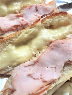 ham and cheese sandwich cut in half on tin foil