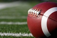 a football sitting on top of a field with the words faith and football