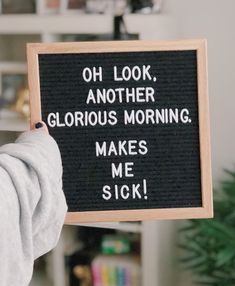 a person holding up a sign that says, oh look another glorious morning makes me sick