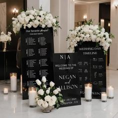 a table with flowers and candles in front of a blackboard sign that says welcome to the wedding