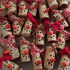 a bunch of wine corks that have been wrapped in red and white plaid ribbon