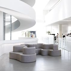 an office lobby with modern furniture and white walls