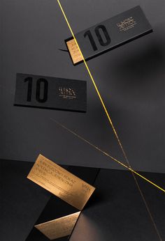 two black and gold business cards with one number on the front, another in the back