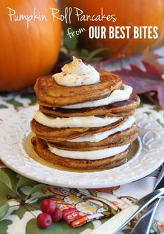 a stack of pancakes sitting on top of a white plate next to a small pumpkin