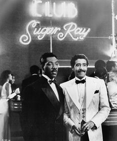 two men standing next to each other in front of a sign that says club sugar ray