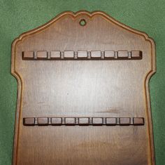 a wooden board with numbers on it sitting on a green surface