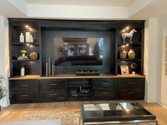 a living room with a large entertainment center