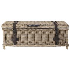 a large wicker trunk with leather straps on the handles and bottom, sitting against a white background