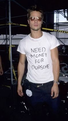 a man with sunglasses standing in front of a drum set and wearing a t - shirt that says need money for porsche