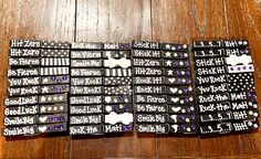 several black and white stickers on a wooden table