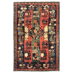 an antique rug with many different colors and designs on it, including red, green, black