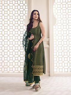 This great winter ensemble from Malaika Arora is perfect for your next special occasion. It includes a bottle green kurta set crafted from silk blend brocade, cotton and organza. Featuring Zari woven designs, a U-neck and calf length trousers, this set is sure to make a statement. It is dry clean only and designed specifically by the Bollywood Diva herself. TOP: Silk Blend(Brocade), TOP INNER: Cotton, BOTTOM: Cotton, DUPATTA: Organza, Dry Clean Cotton Suit Designs Sleeveless, Green Suit Designs Indian Style, Short Kurta Suits Women, Bottle Green Suits Women Indian, Brocade Kurta Set, Sleeveless Salwar Designs, Green Kurta Set Women, Kurta Designs Women Sleeveless, Trendy Suit Designs For Women